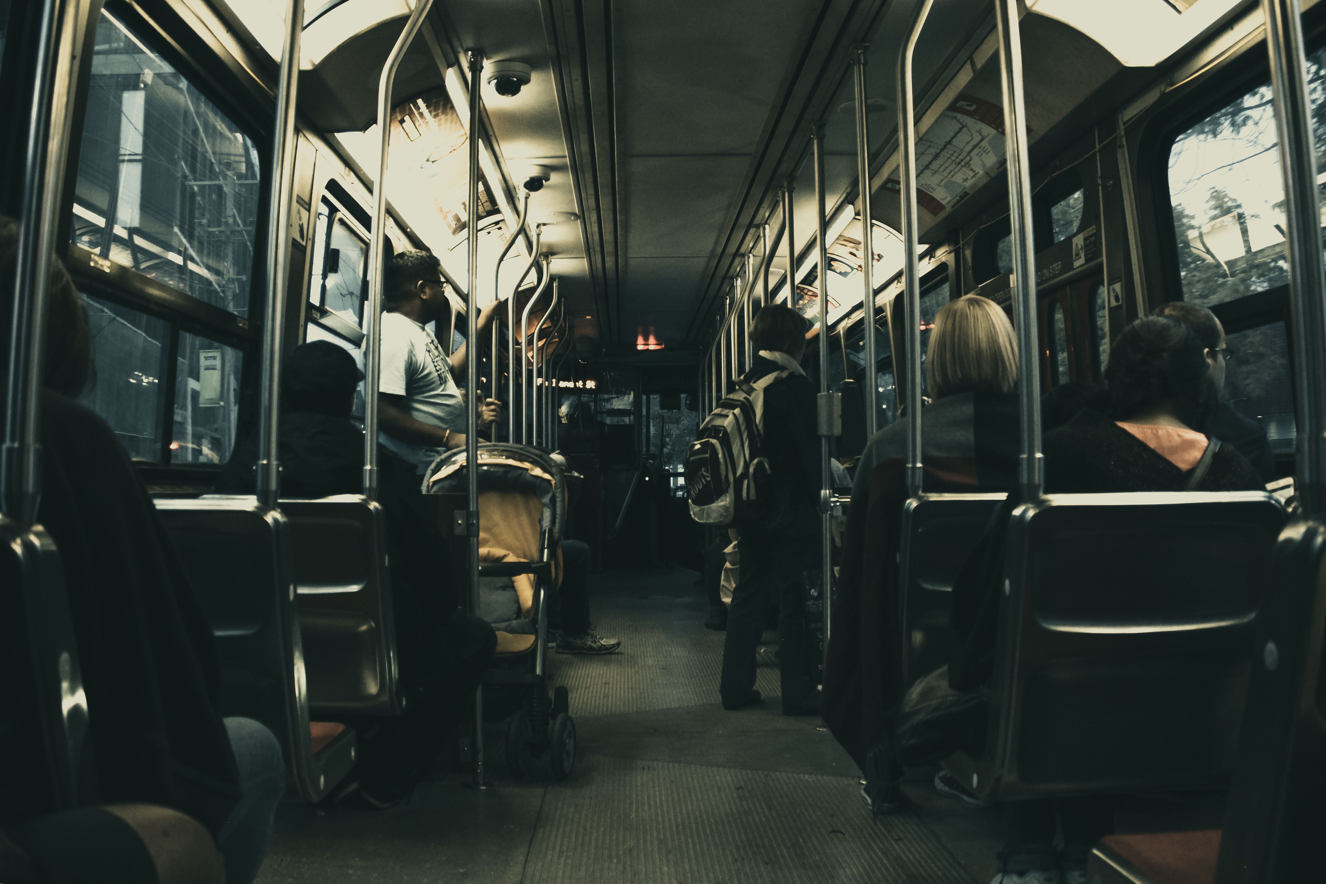 Passengers riding a city bus at night, illustrating commuting and public transportation costs.
